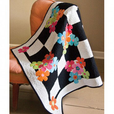 Black and white square with colorful flowers quilt
