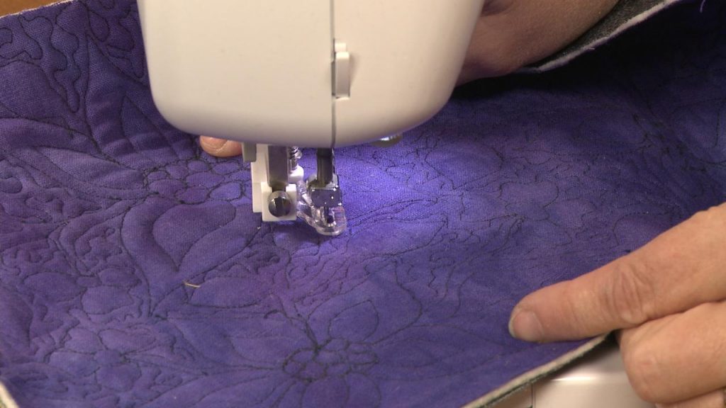 Quilting on purple fabric