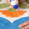 Putting glue on fabric