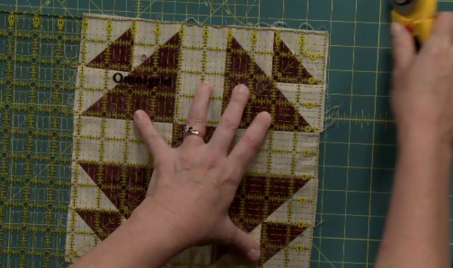 Using a quilting ruler over fabric