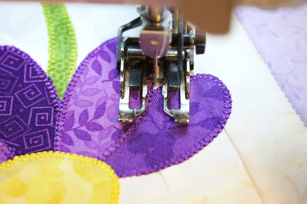 Stitching around purple petals