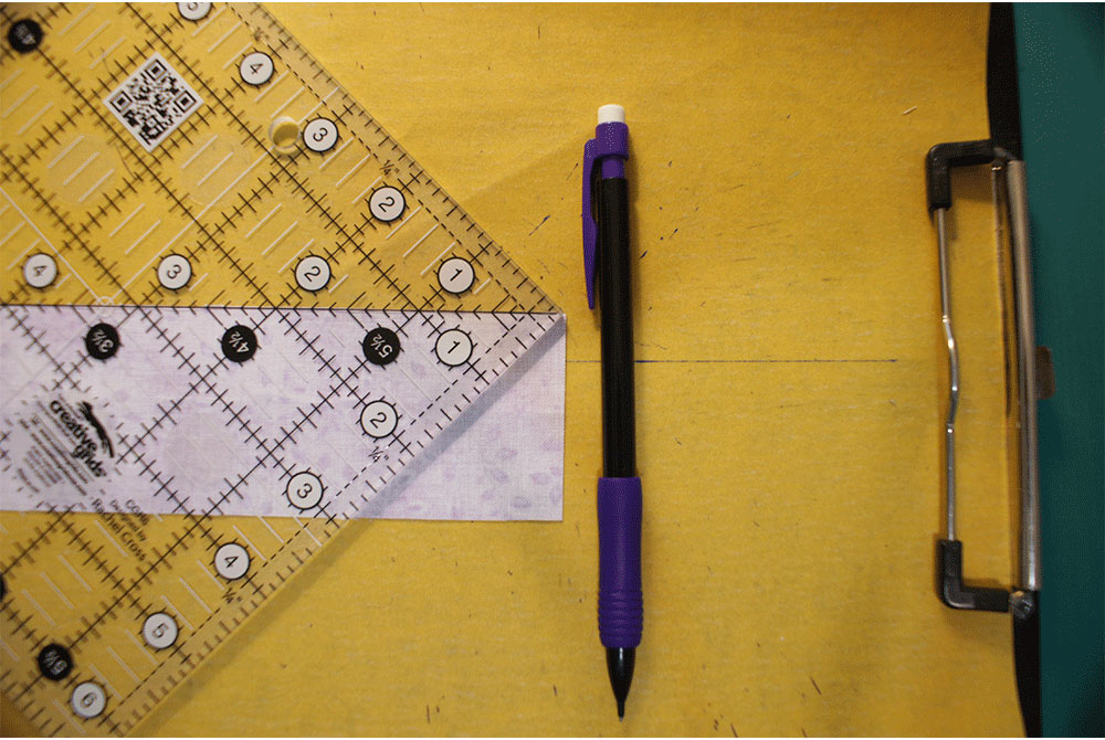 Measuring grid with a pencil on a clipboard