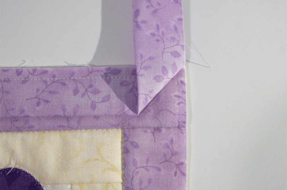 Folded corner of purple fabric trip