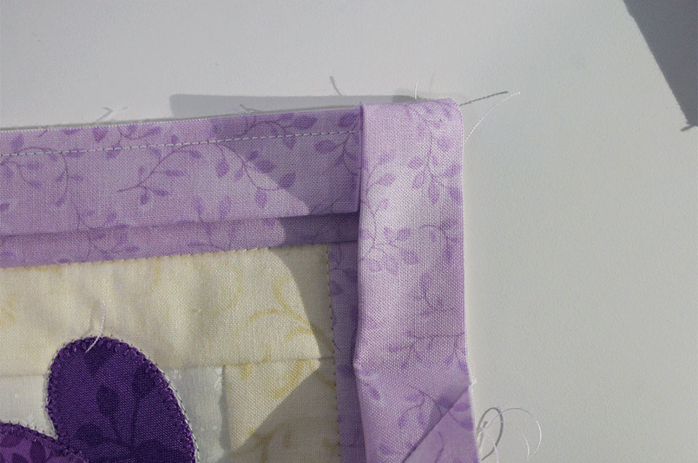 Folding corner of fabric strip