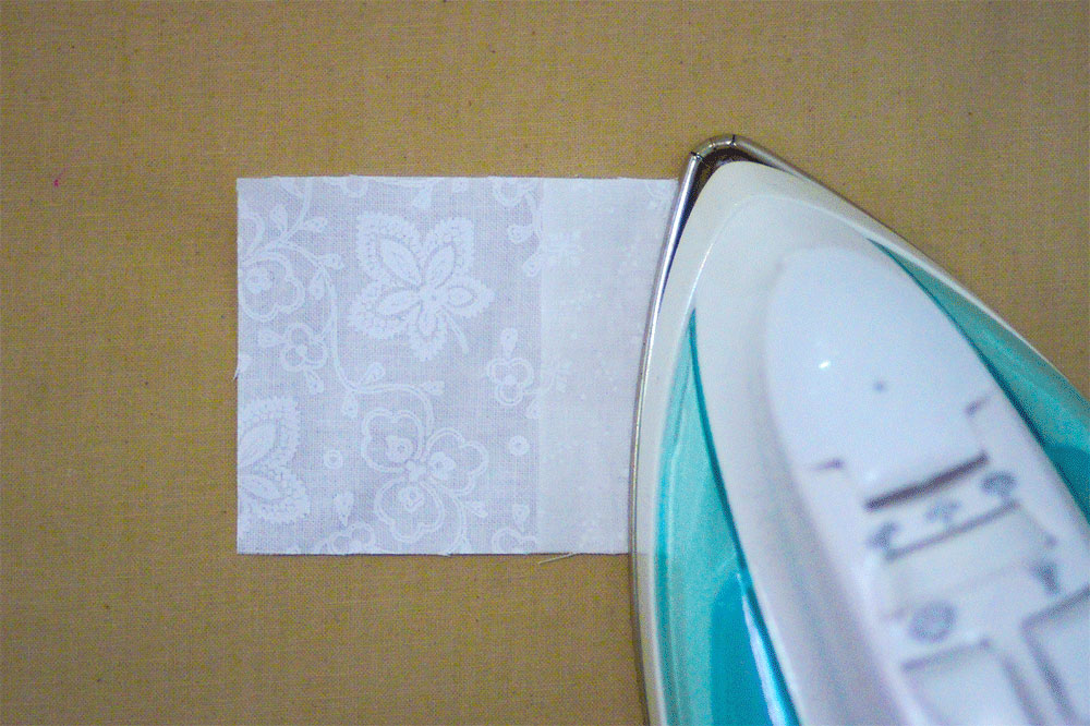 Ironing a white piece of fabric