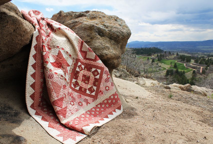 Quilt laying over an outdoor rock