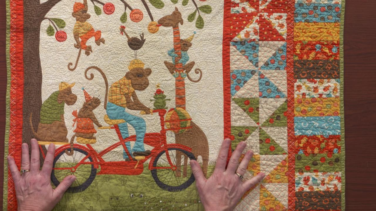 Quilt with monkeys riding a bike
