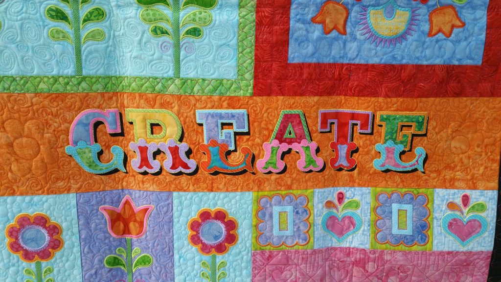 quilt with word create on it