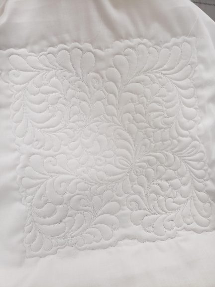 white quilt with design stitching