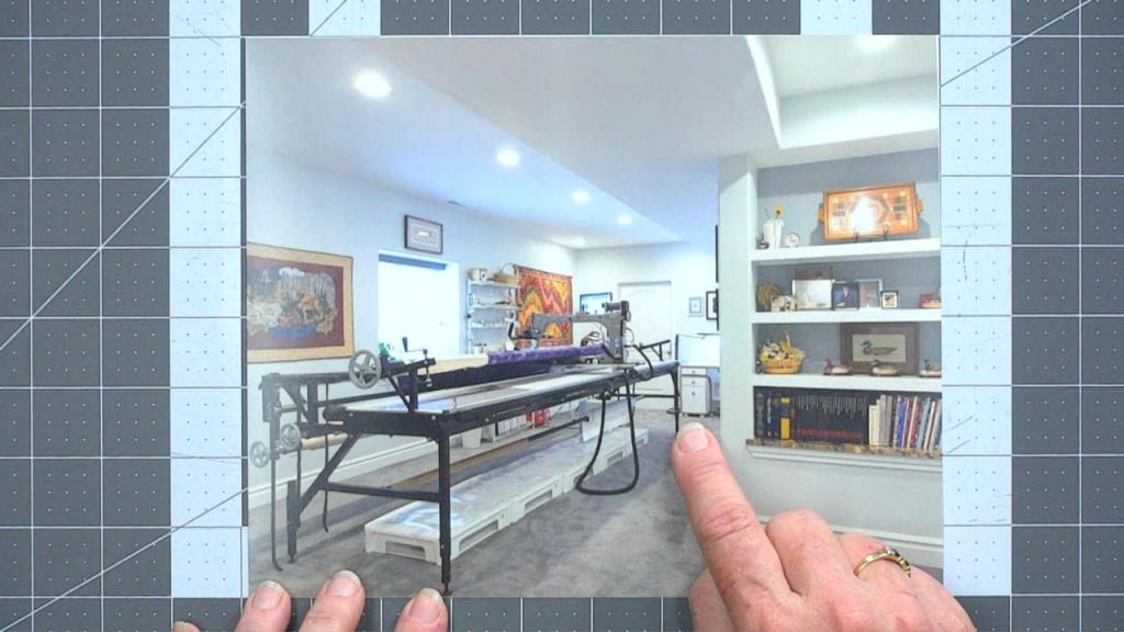 Pointing to a picture of a long arm quilting machine