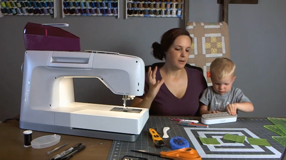 Screenshot of a woman quilting with a child