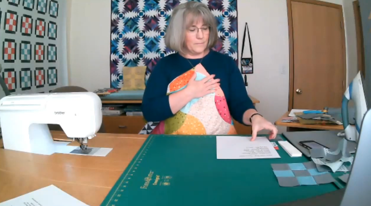 Screenshot of a woman quilting on video