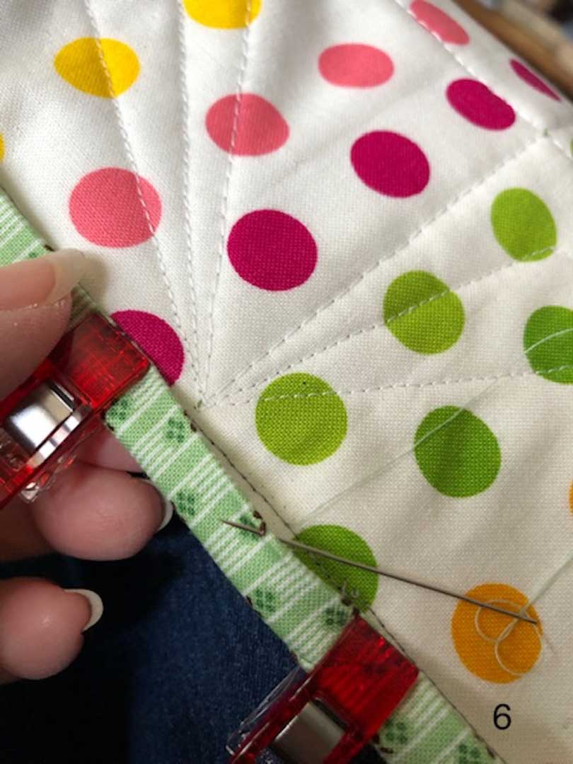 putting a small stitch in the binding fold