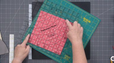 Quilting ruler on pink fabric