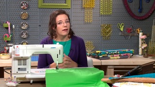 Woman sewing lime green fabric with a sewing machine