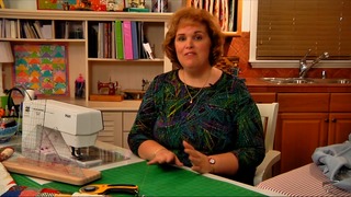 Woman talking at a sewing table