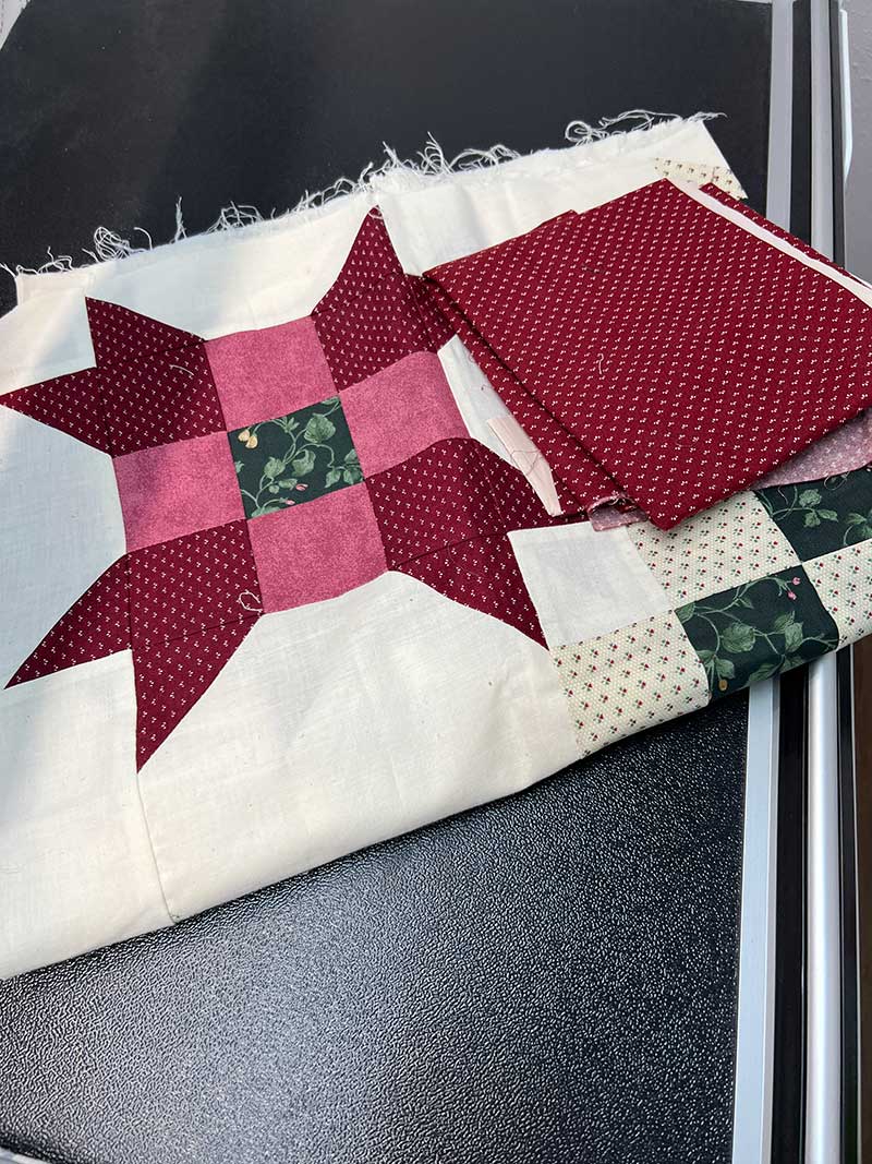 part of a quilt with red pieces