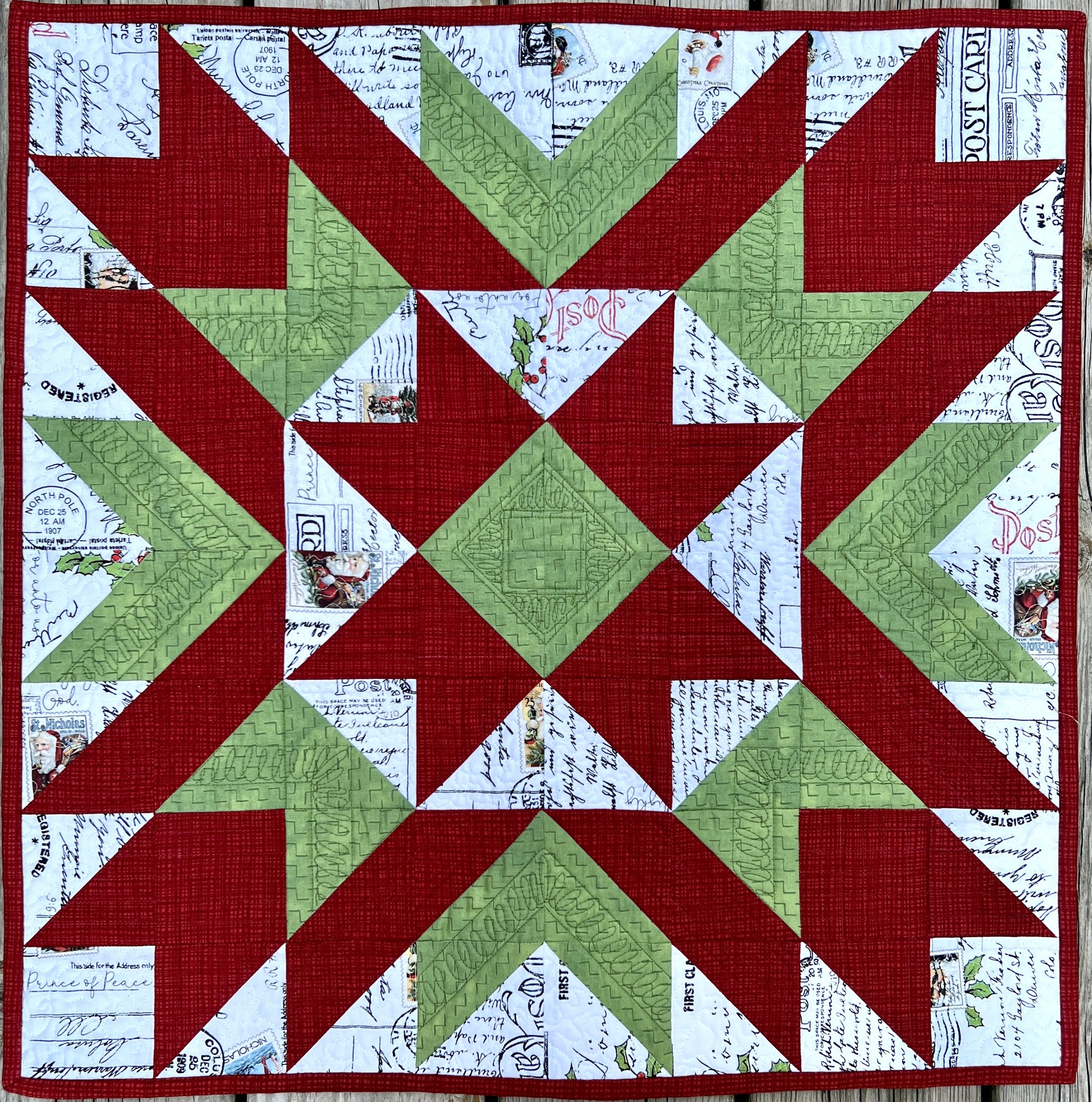 A red and green 24x24 inch quilted table topper in a classic quilted star