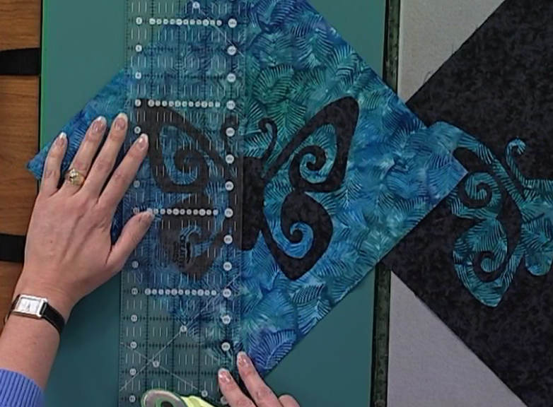 Quilting ruler on a butterfly print square