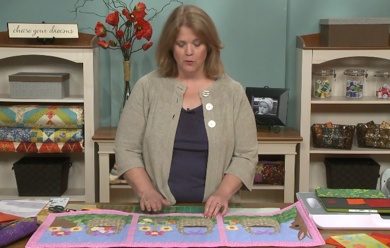 Woman with a spring quilt on a table