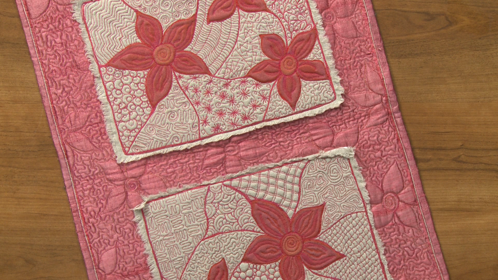 Close up of flower embroidered quilt