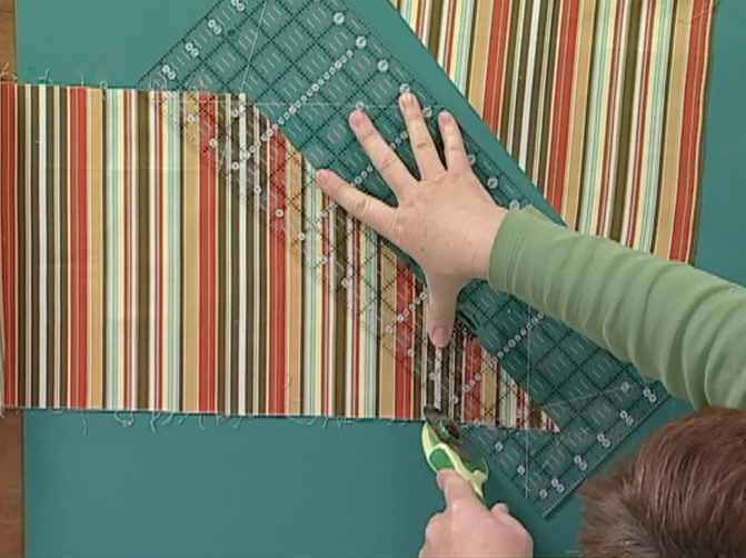 Cutting with a rotary cutter against a quilting ruler