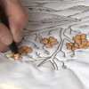 Coloring a quilted flower on white fabric