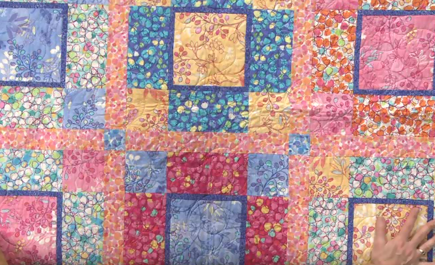 Completed quilt with flower fabrics