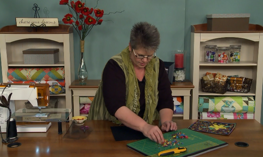 Woman with quilting tools at a table