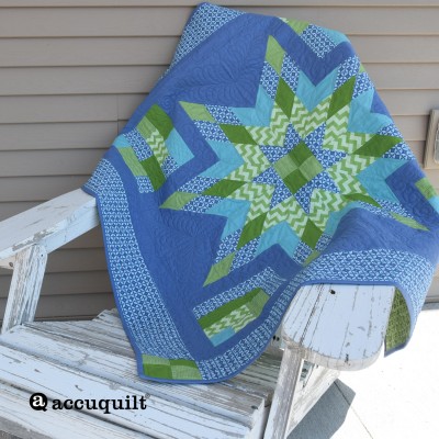Star quilt hanging over an Adirondack chair