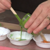 Pouring green paint into a bowl