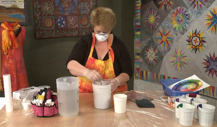 Woman mixing dye for fabric