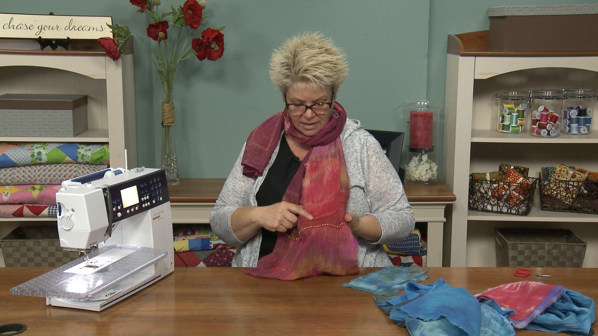 Woman at a sewing table with a scarf
