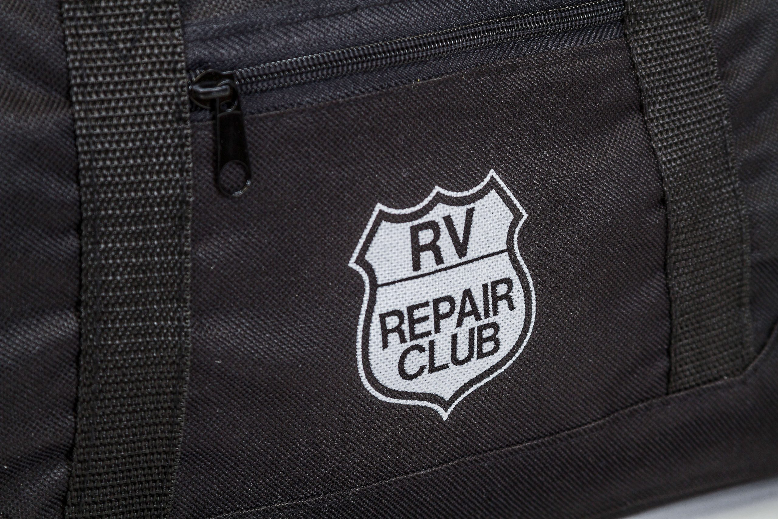 RV Repair Club logo on a duffle bag