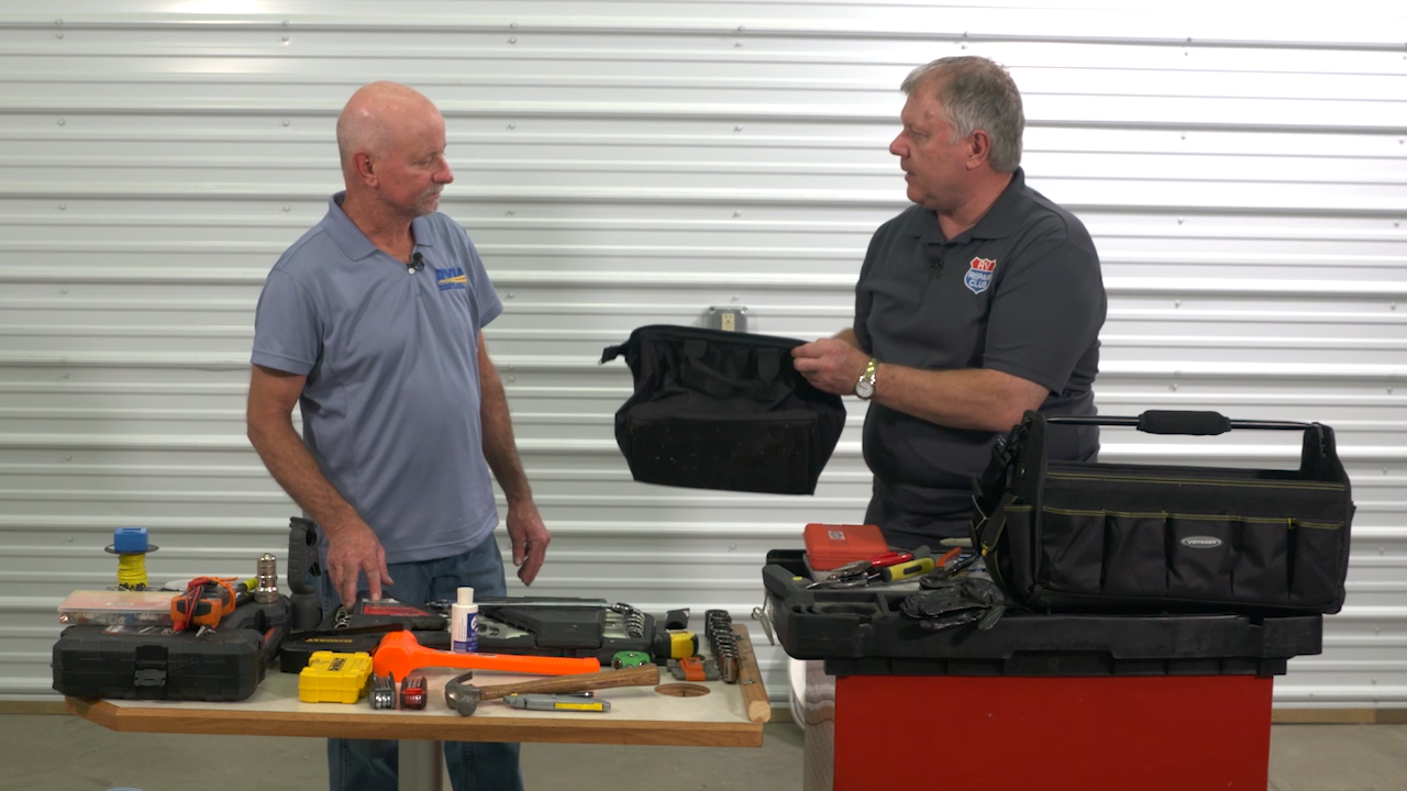 Two men talking with a table full of RV tools