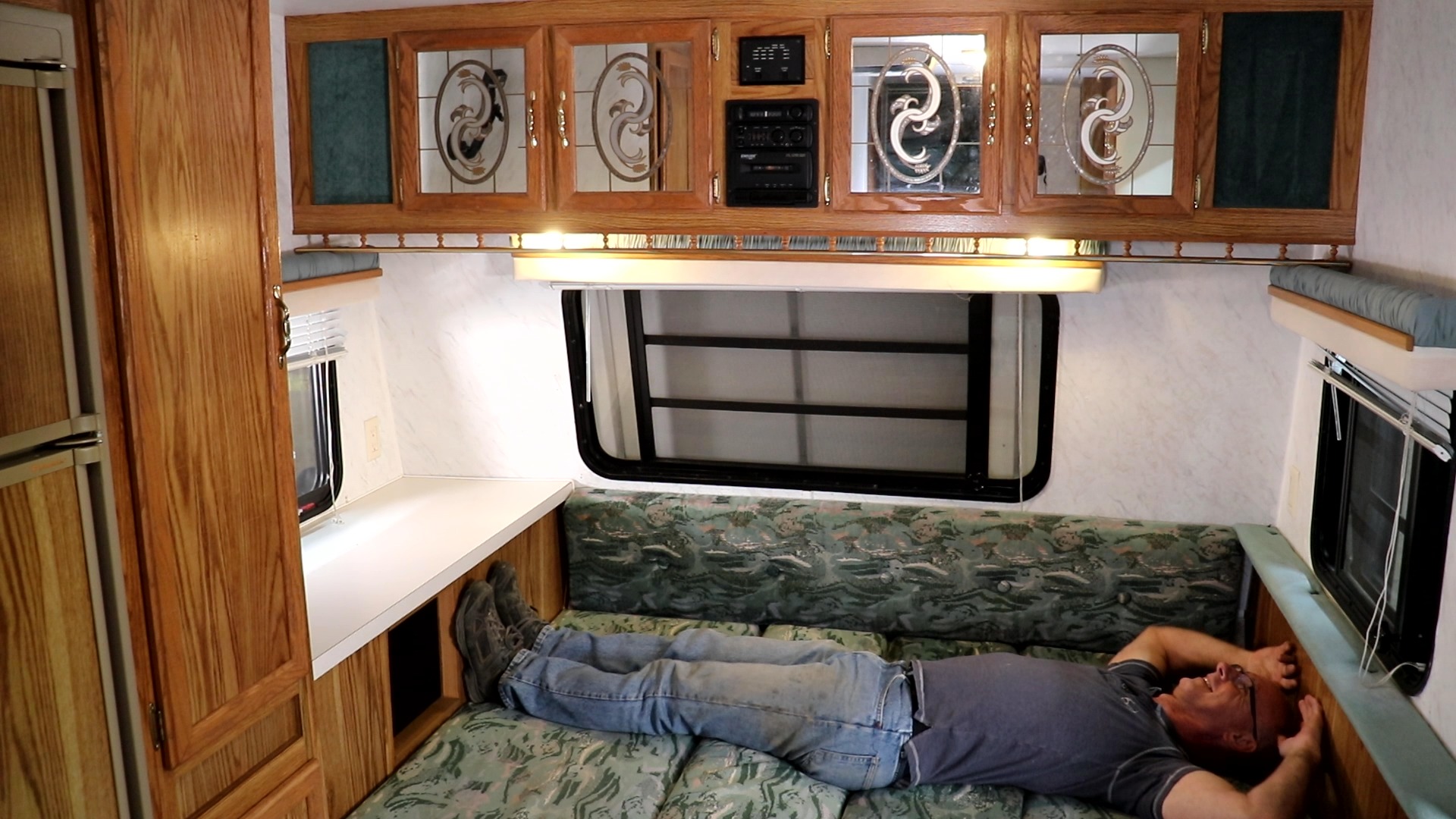 Man laying down in an RV bend