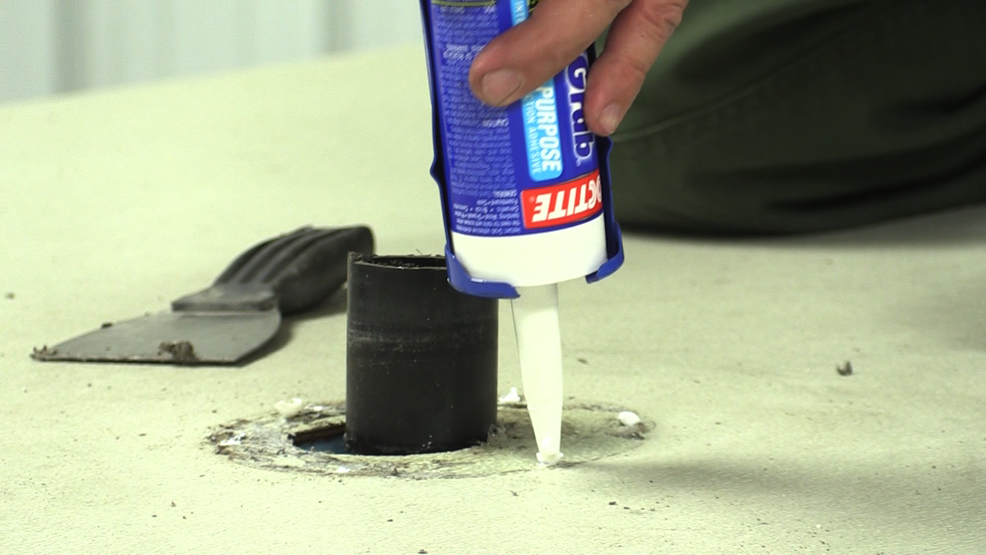 Putting glue around a hole for a pipe