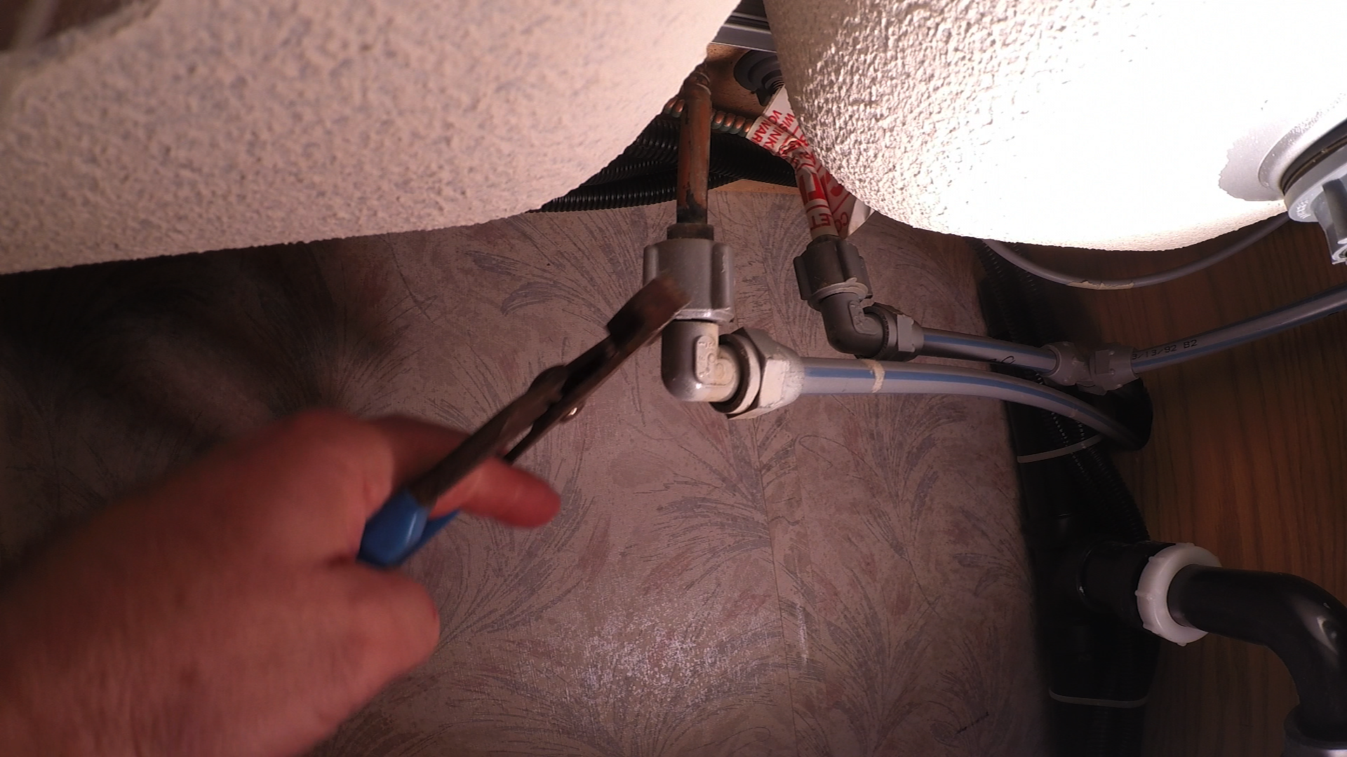 Fixing a pipe under a sink