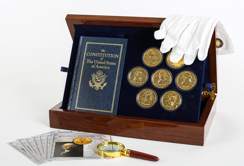 Founding fathers of America coin collection with white gloves draped over the box