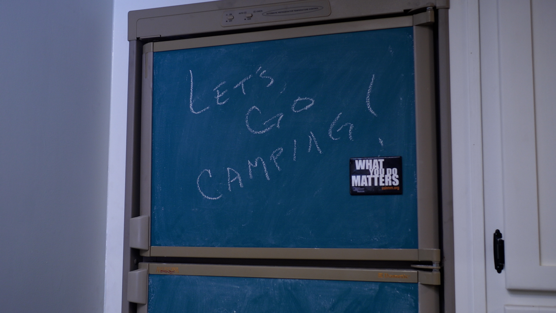 Let's go camping written on a chalkboard