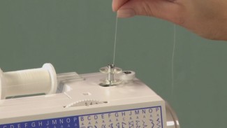 Preparing a sewing machine with thread