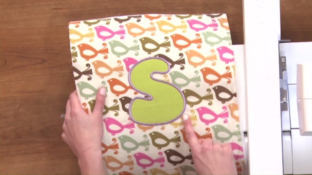 Letter S embroidered on bird fabric
