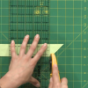 Cutting a strip of paper with a rotary cutter