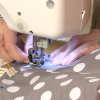 Sewing a white and tan polka dot bag