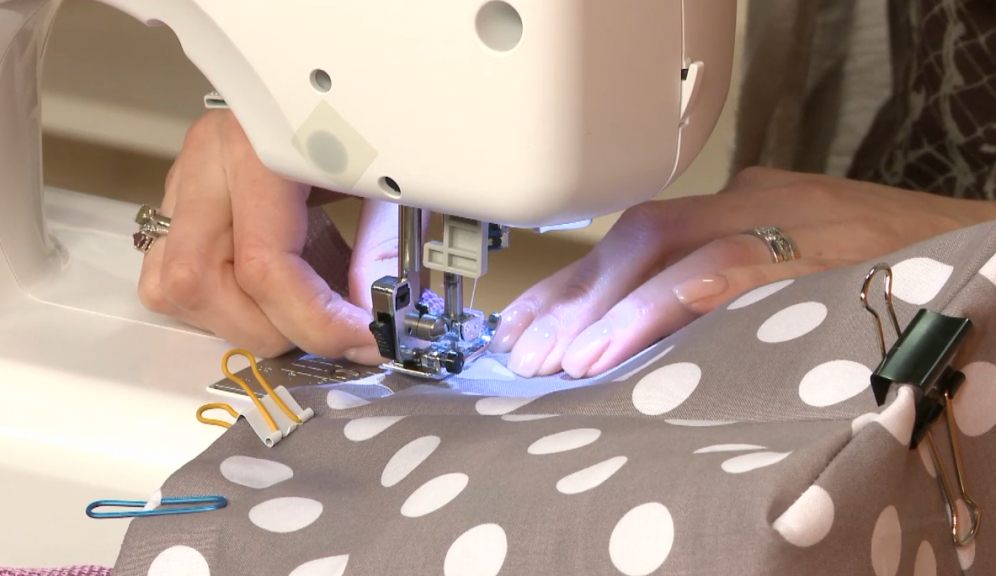 Sewing a white and tan polka dot bag