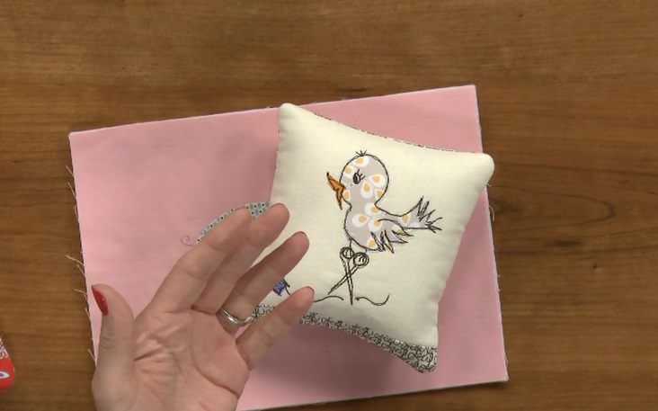 Bird stitching on a pillow