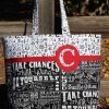 Tote bag on a fence post