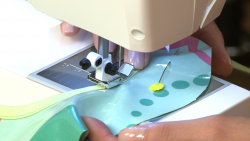 Sewing a border on a colorful bib