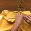 Sewing an elastic hem on a yellow skirt