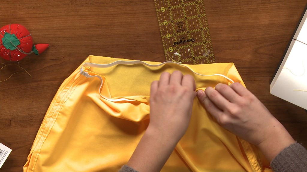 Sewing an elastic hem on a yellow skirt